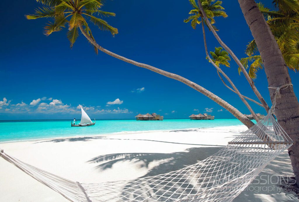 hero shot Gili Lankanfushi maldives dhoni gliding on the resort blue lagoon